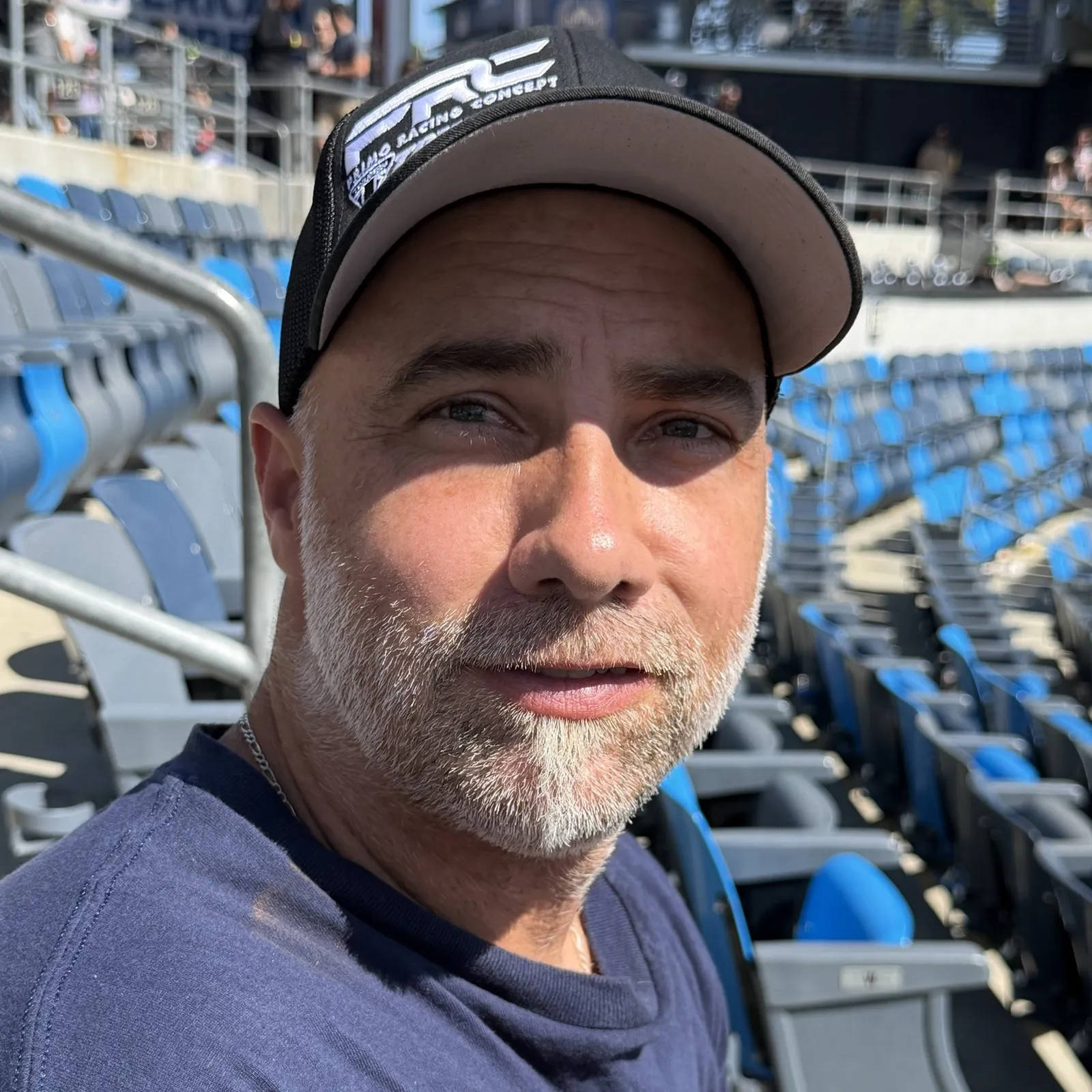 Jon Primo wearing a PRC cap in the stands