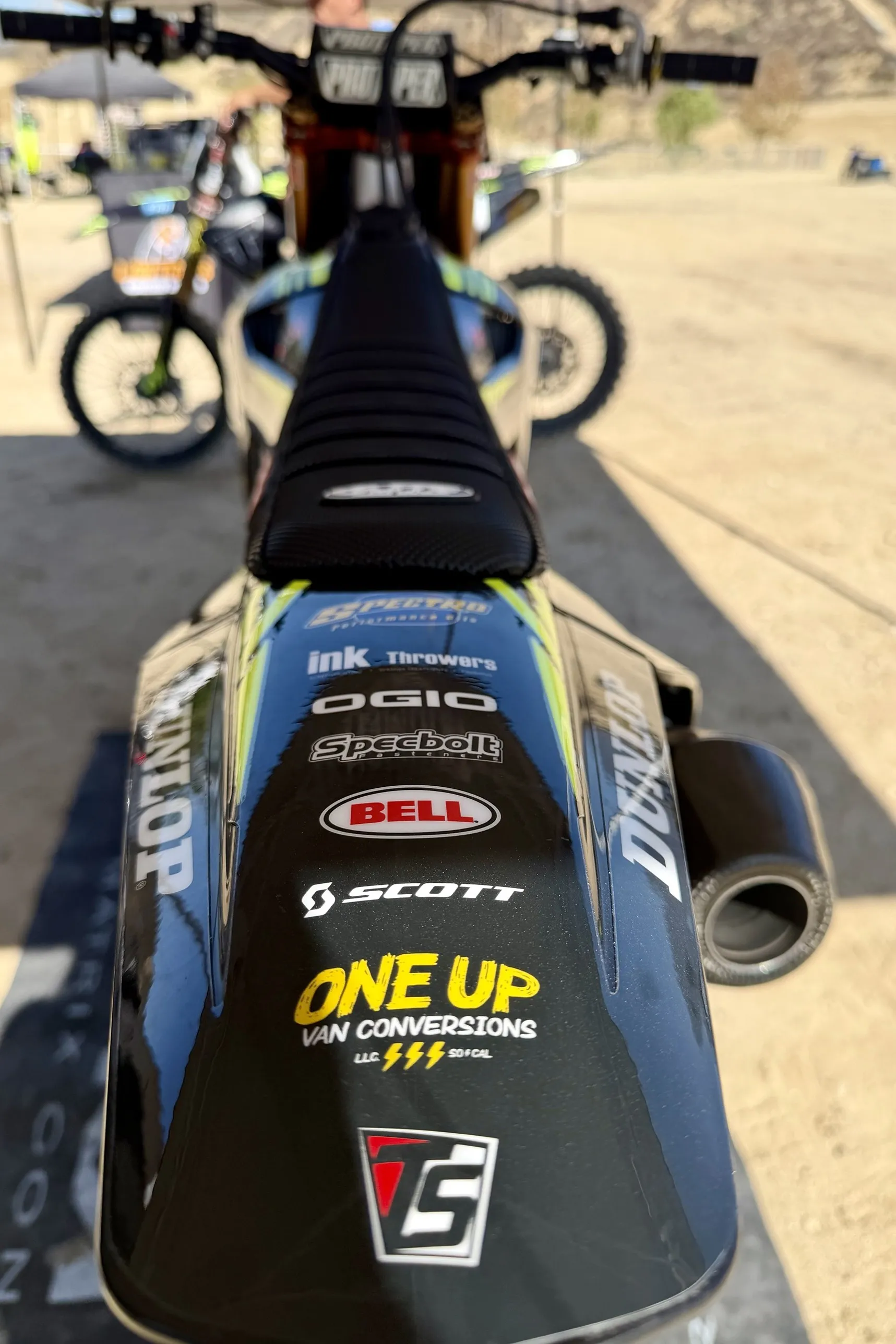 The PRC Triumph seat and rear fender covered in partner logos
